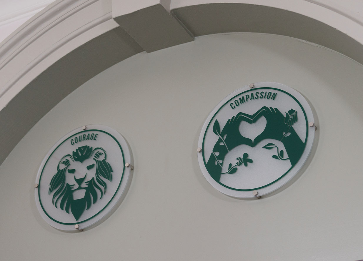 Circular school signs showing different values of the schools