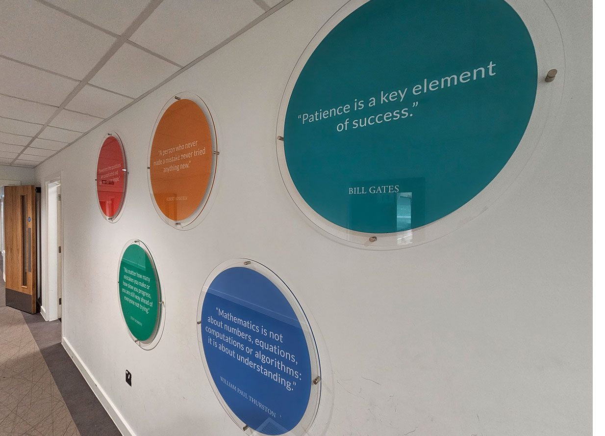 School signage discs with quotes from famous people
